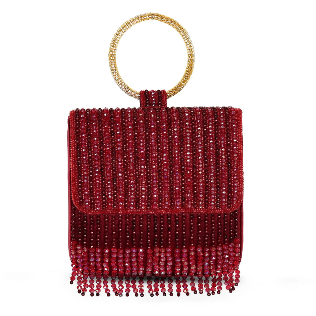 A mehroon (maroon) colored embroidered clutch with a round golden handle and beaded fringe.