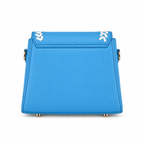 A bright blue structured leather handbag shown from the back, featuring gold-tone hardware and white chevron accents on the top flap.