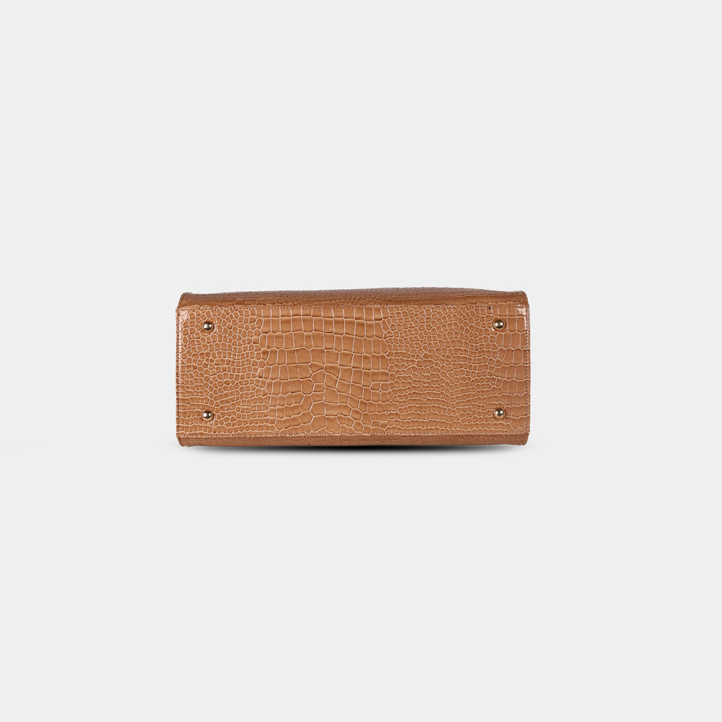 Bottom base of brown snake-textured handbag featuring four protective metal studs