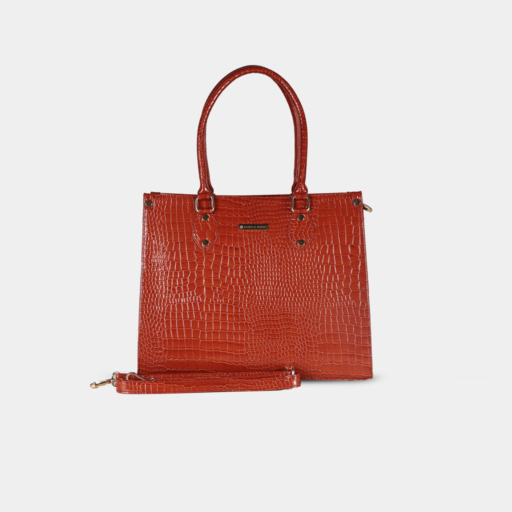 Front view of red snake-textured handbag highlighting structured body and detachable strap attachment