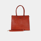 Front view of red snake-textured handbag highlighting structured body and detachable strap attachment