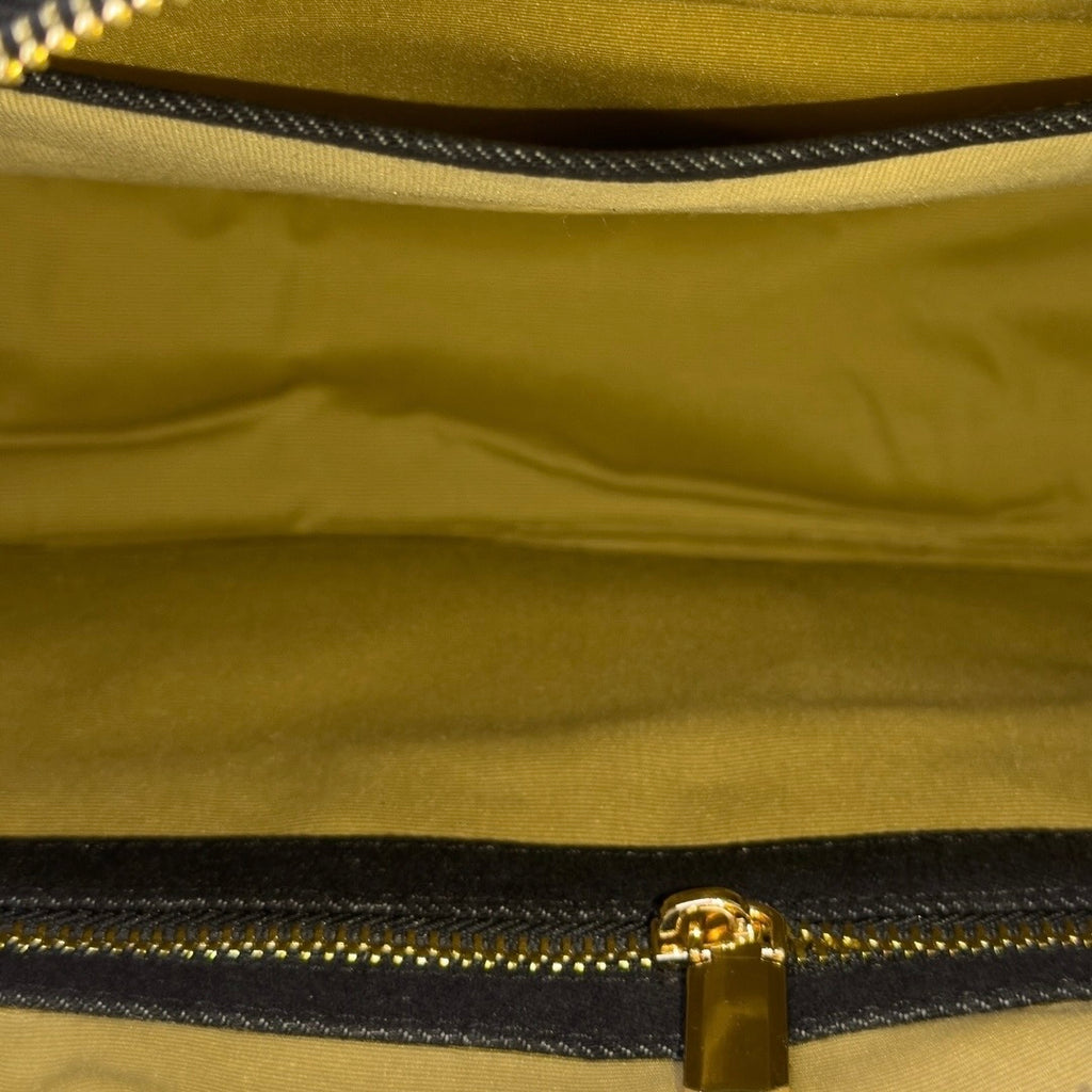 Interior of black Frida sling bag with organized compartments