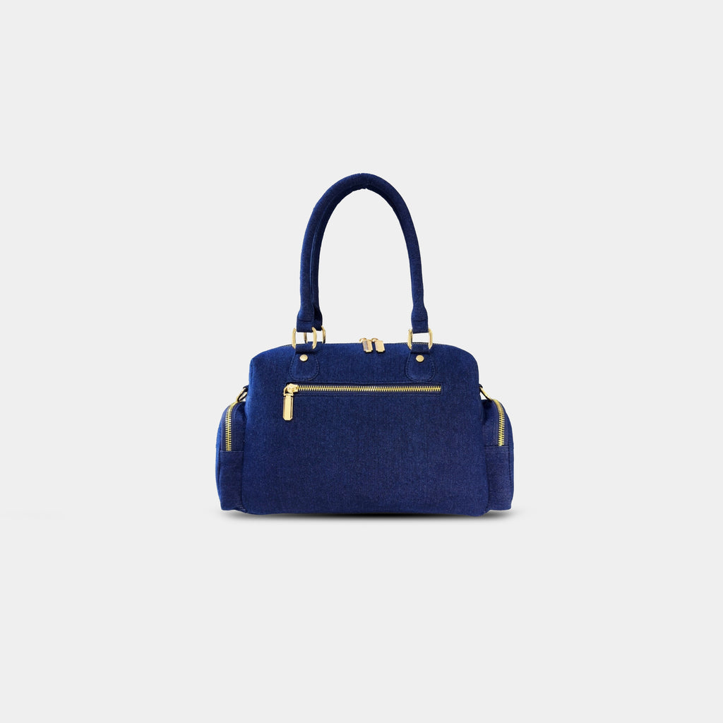 Back zipper pocket view of dark blue Frida sling bag