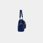 Side view of dark blue Frida sling bag with zipper pocket