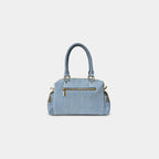 Back view of light blue Frida denim sling bag with secure zipper pocket