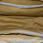 Interior of light blue Frida denim sling bag showing main compartment and inner pockets