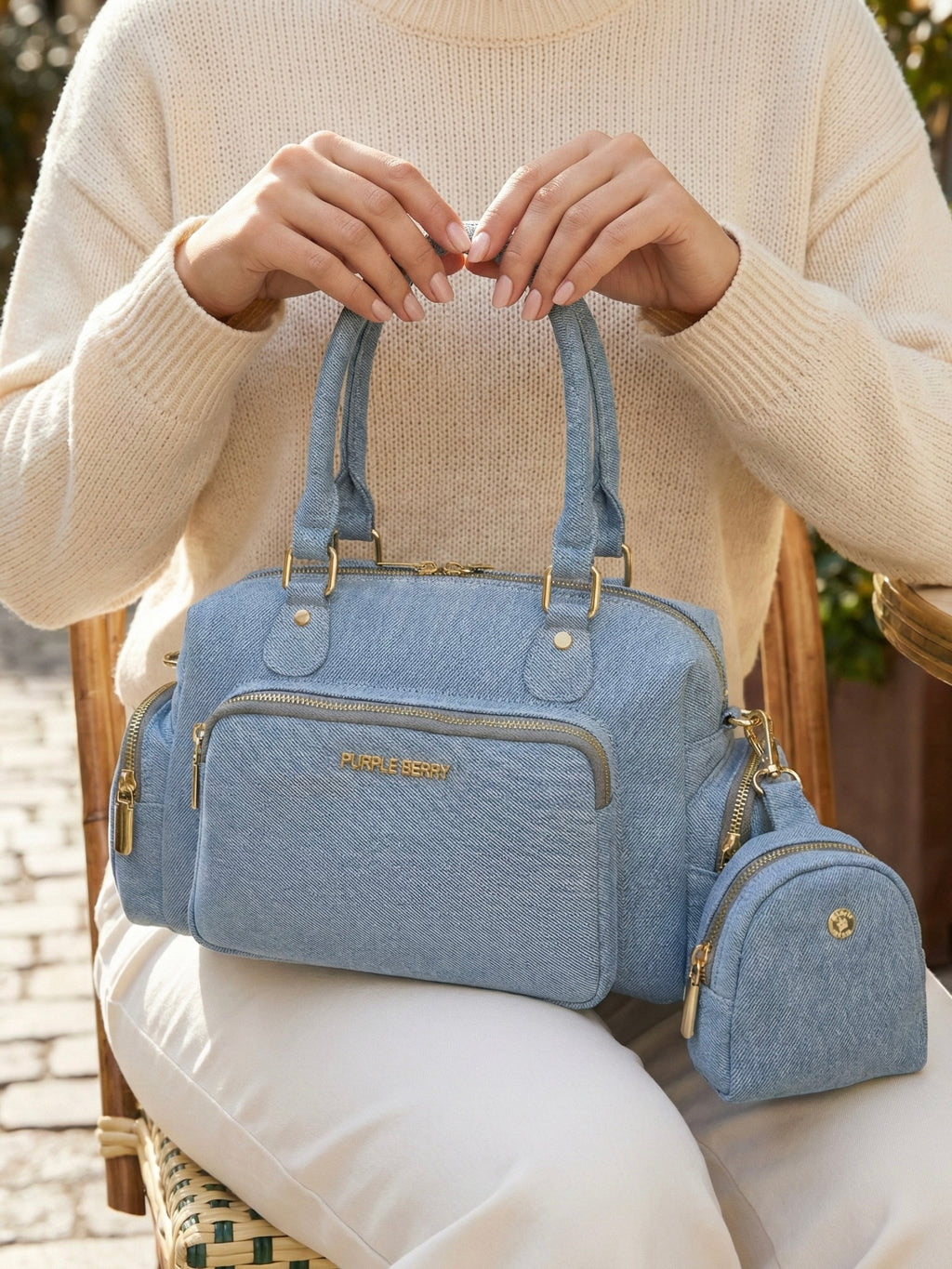 Model carrying light blue Frida denim sling bag with matching coin pouch