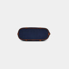 Bottom view of dark blue Harper denim handbag featuring four protective metal base studs