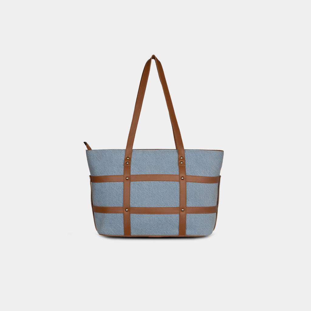Back view of light blue Harper denim handbag showing clean structure and faux leather detailing