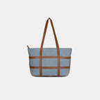 Back view of light blue Harper denim handbag showing clean structure and faux leather detailing