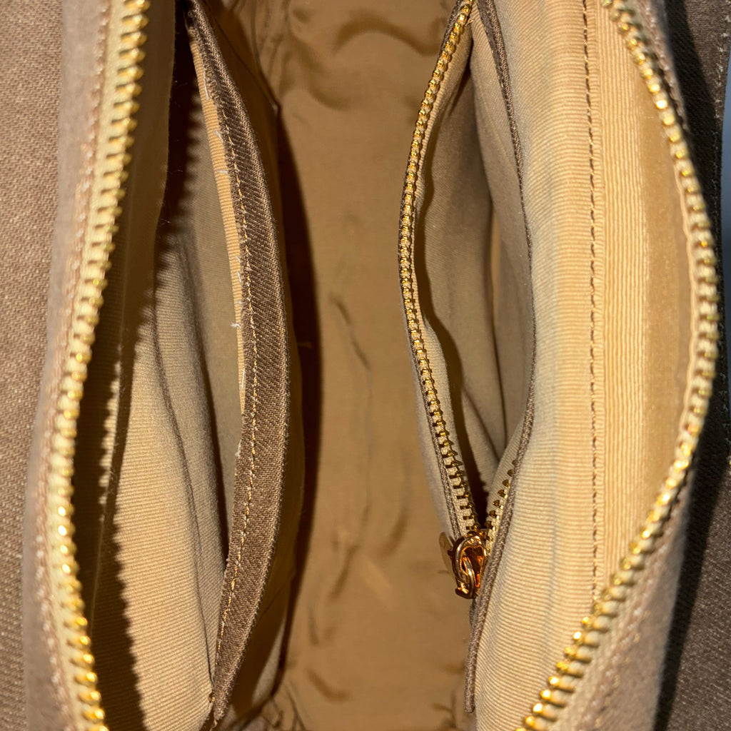Spacious interior of brown Hera denim handbag with organized pockets