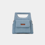 Magnetic front flap pocket detail of light blue Hera handbag