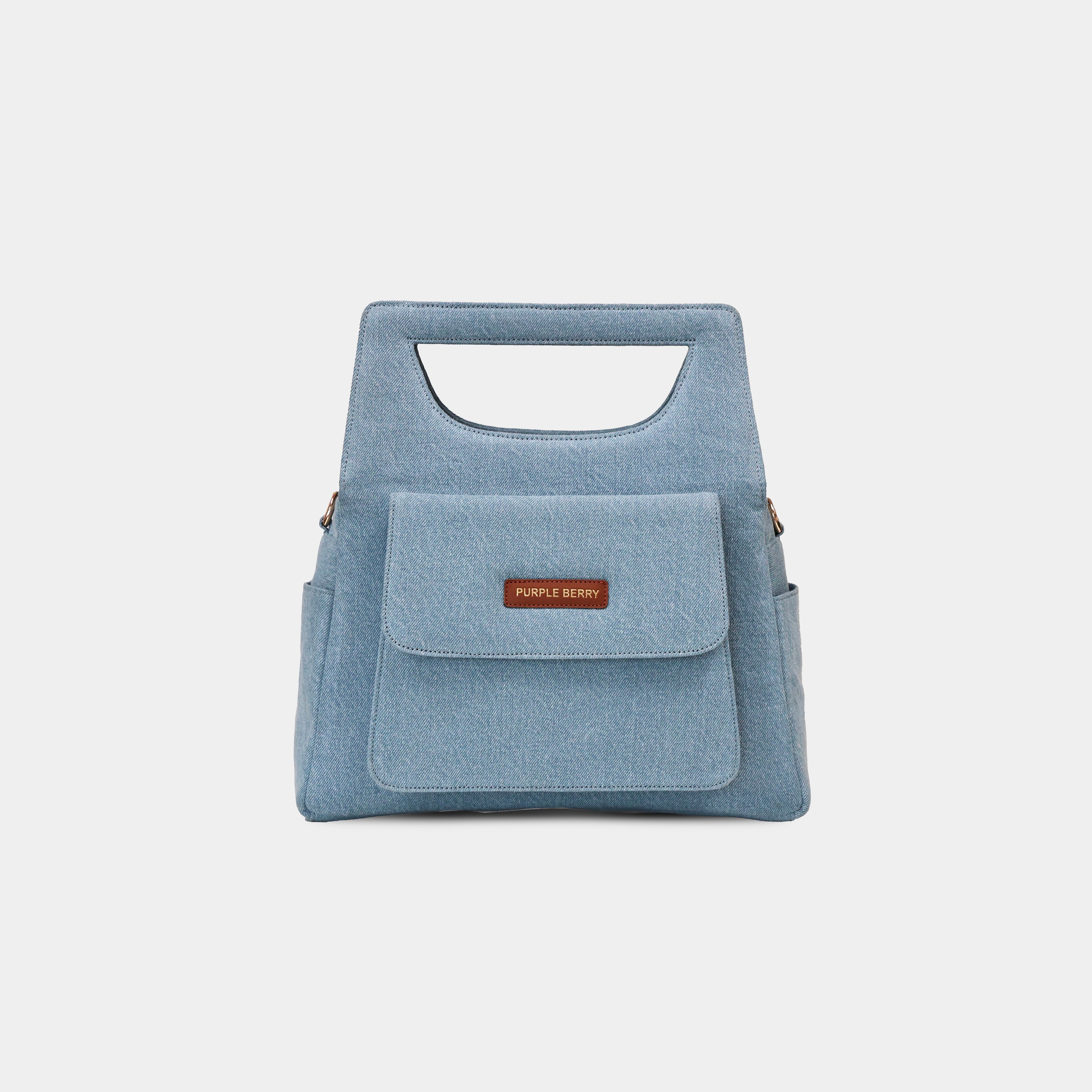 Magnetic front flap pocket detail of light blue Hera handbag