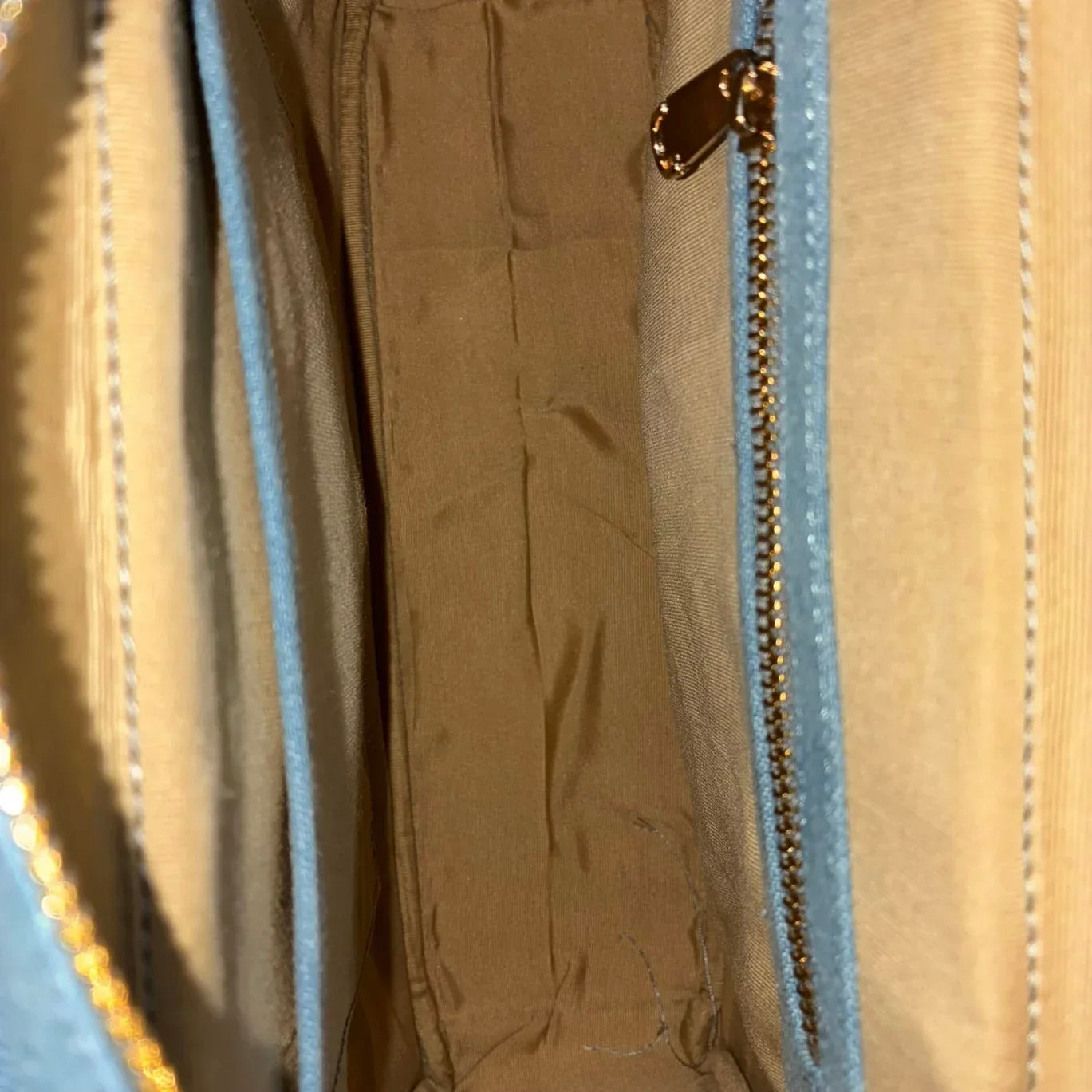 Interior view of light blue Hera denim handbag with zip pocket and slip pocket