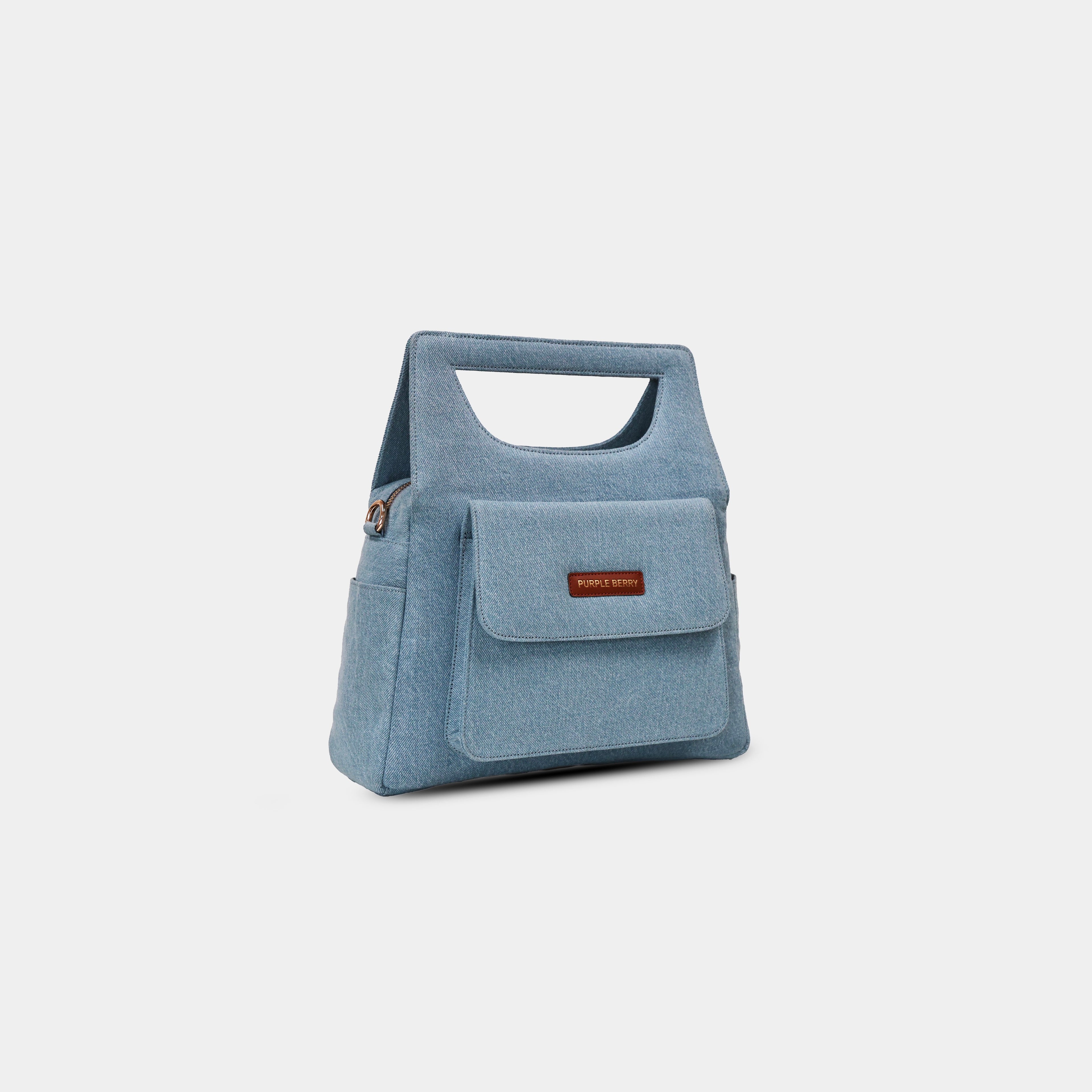 Side profile of light blue Hera denim handbag showing structured shape