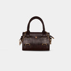 Close-up of detachable gold chain strap on dark brown Lumière mini party bag