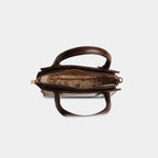 Interior of dark brown Lumière mini party bag with single main compartment and zip closure