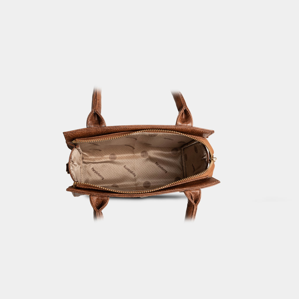 Interior compartment of light brown Lumière mini party bag with zip closure