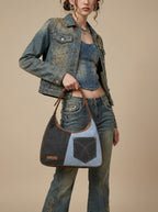 grey and light blue nitya denim shoulder bag worn by a model 