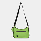 Back view of green Bili denim sling bag featuring secure zipper pocket
