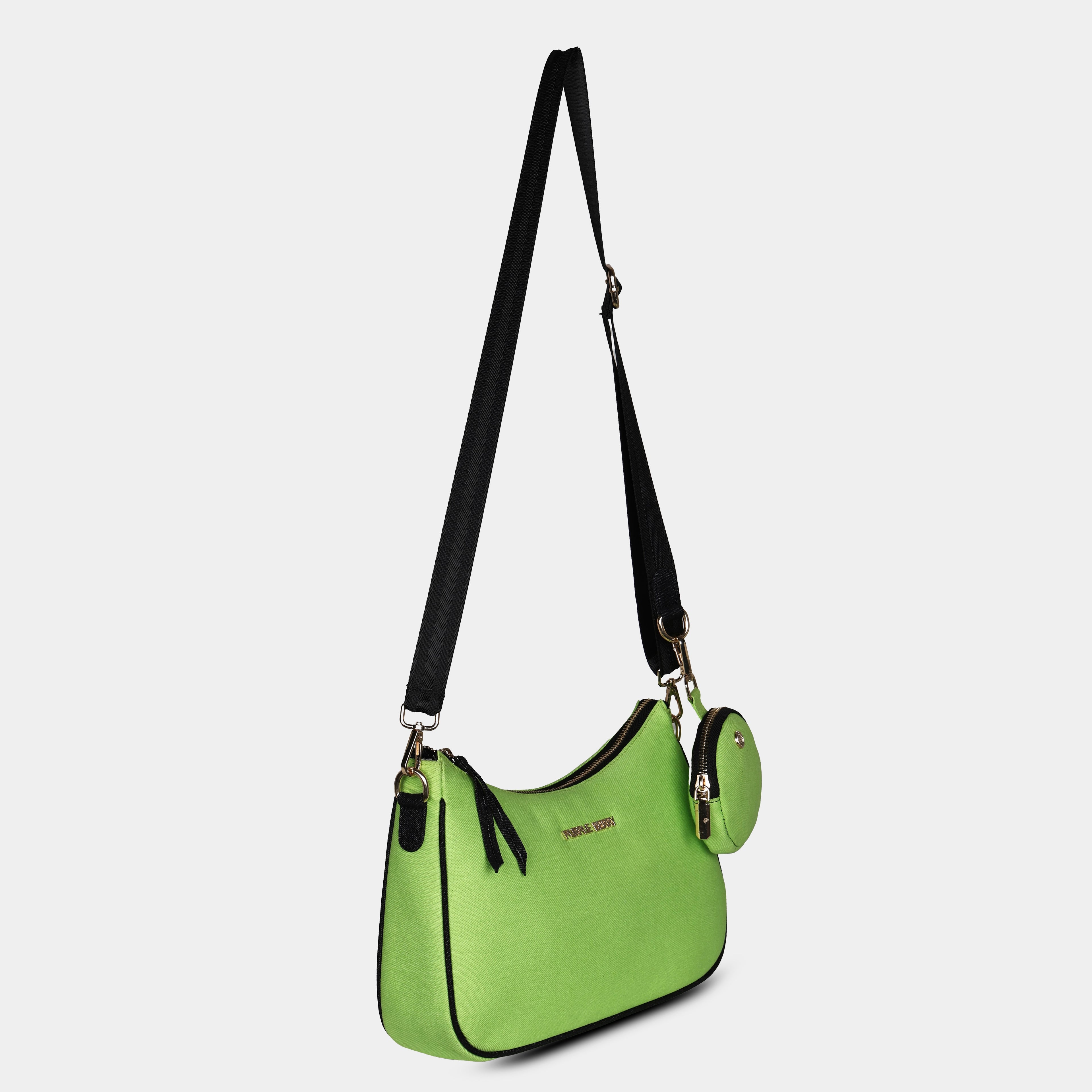 Side angle of green Bili denim sling bag highlighting slim curved silhouette