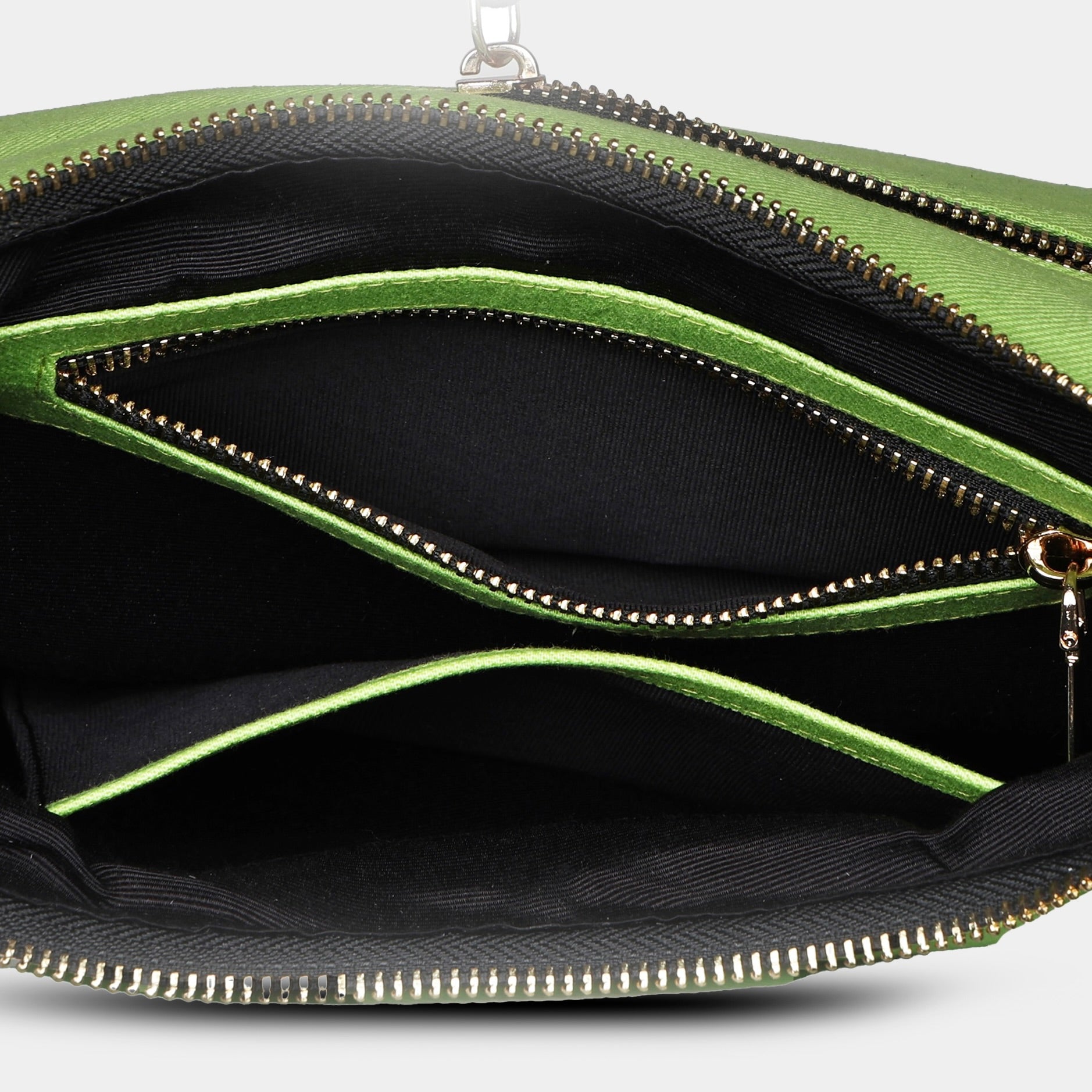 Top open zip view of green Bili denim sling bag featuring secure zipper pocket