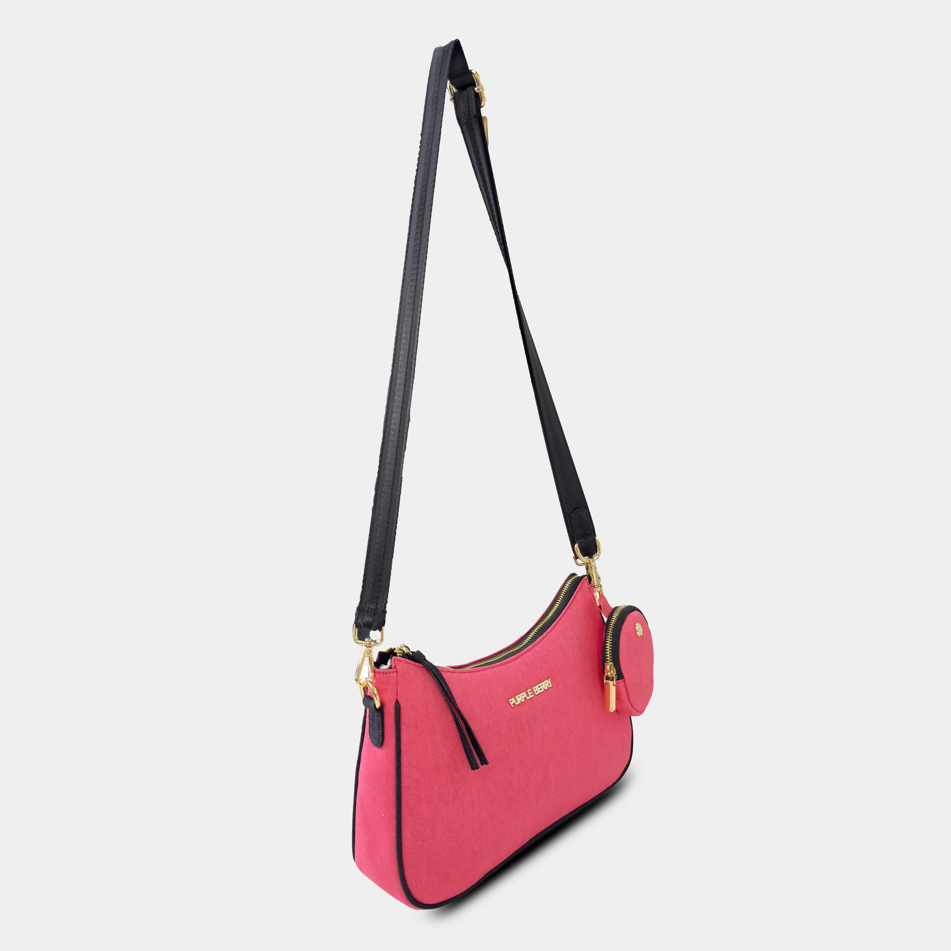 Angled side profile of pink Bili denim sling bag showing curved design and adjustable shoulder strap