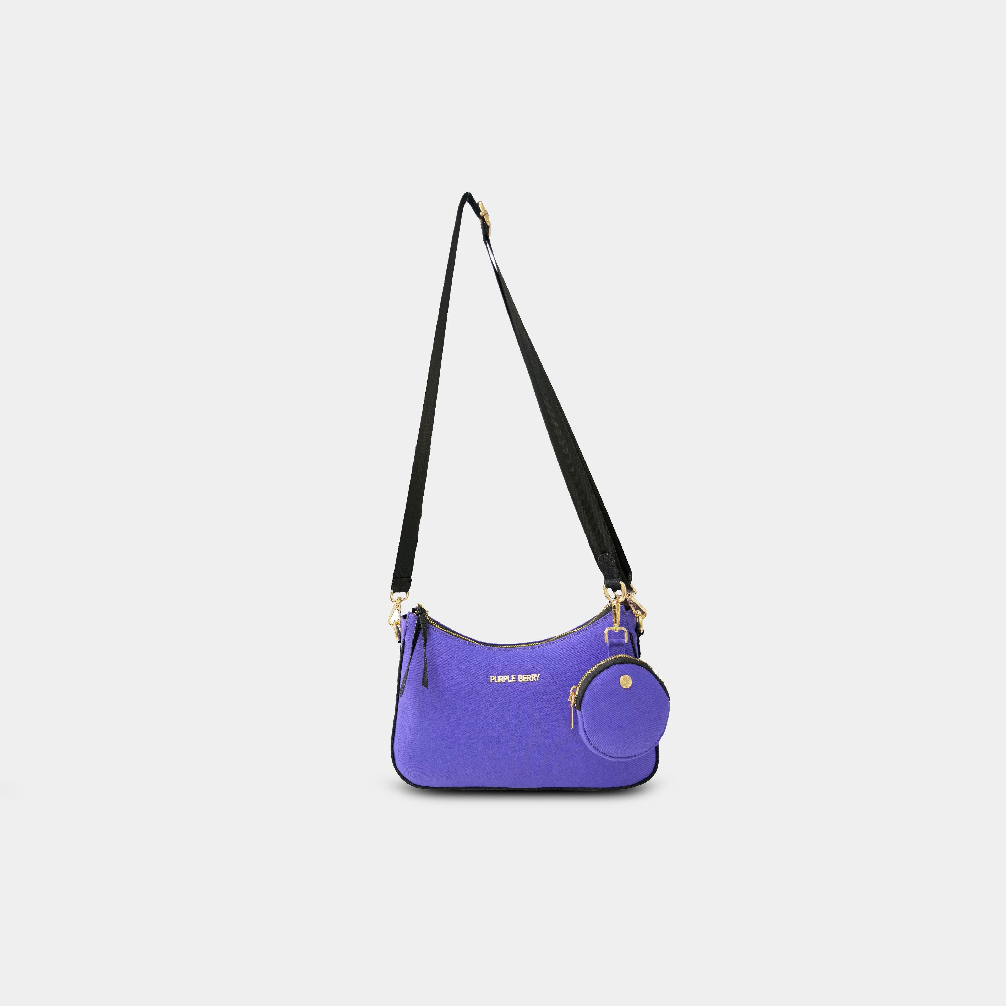 Front hanging view of purple Bili denim sling bag highlighting curved shape and gold hardware