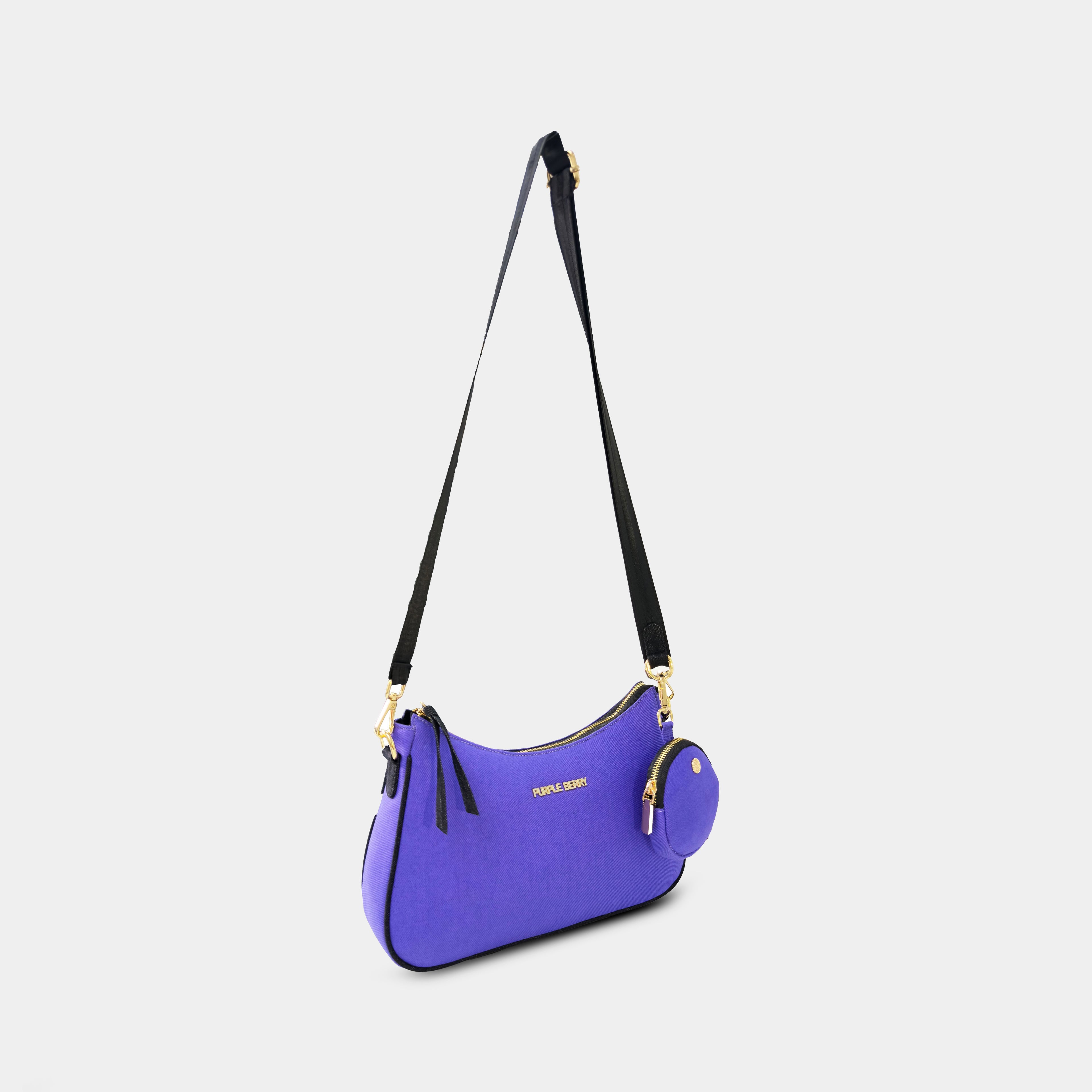 Side angle of purple Bili denim crossbody bag showing curved silhouette and adjustable strap