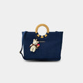 Dark blue Dima denim office tote with round ring handles and teddy charm