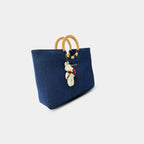 Side angle of dark blue denim tote showing depth and structure