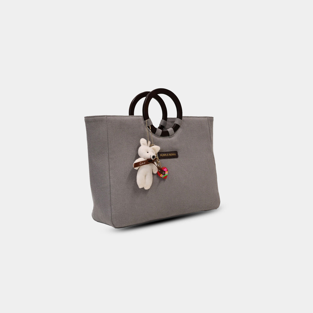 Side angle of grey denim tote showing depth and base width