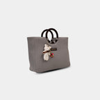Side angle of grey denim tote showing depth and base width