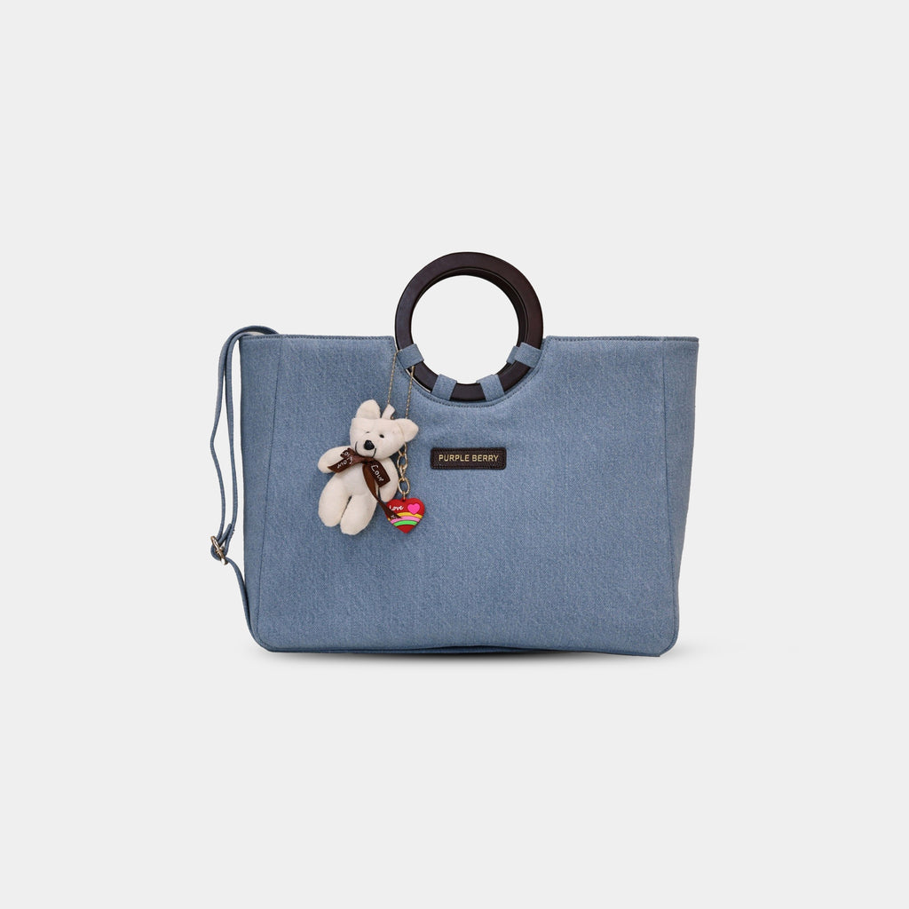 Light blue Dima denim office tote bag with round ring handles and teddy bear charm attached