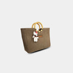 Side angle of mocha mousse denim tote showing structured profile