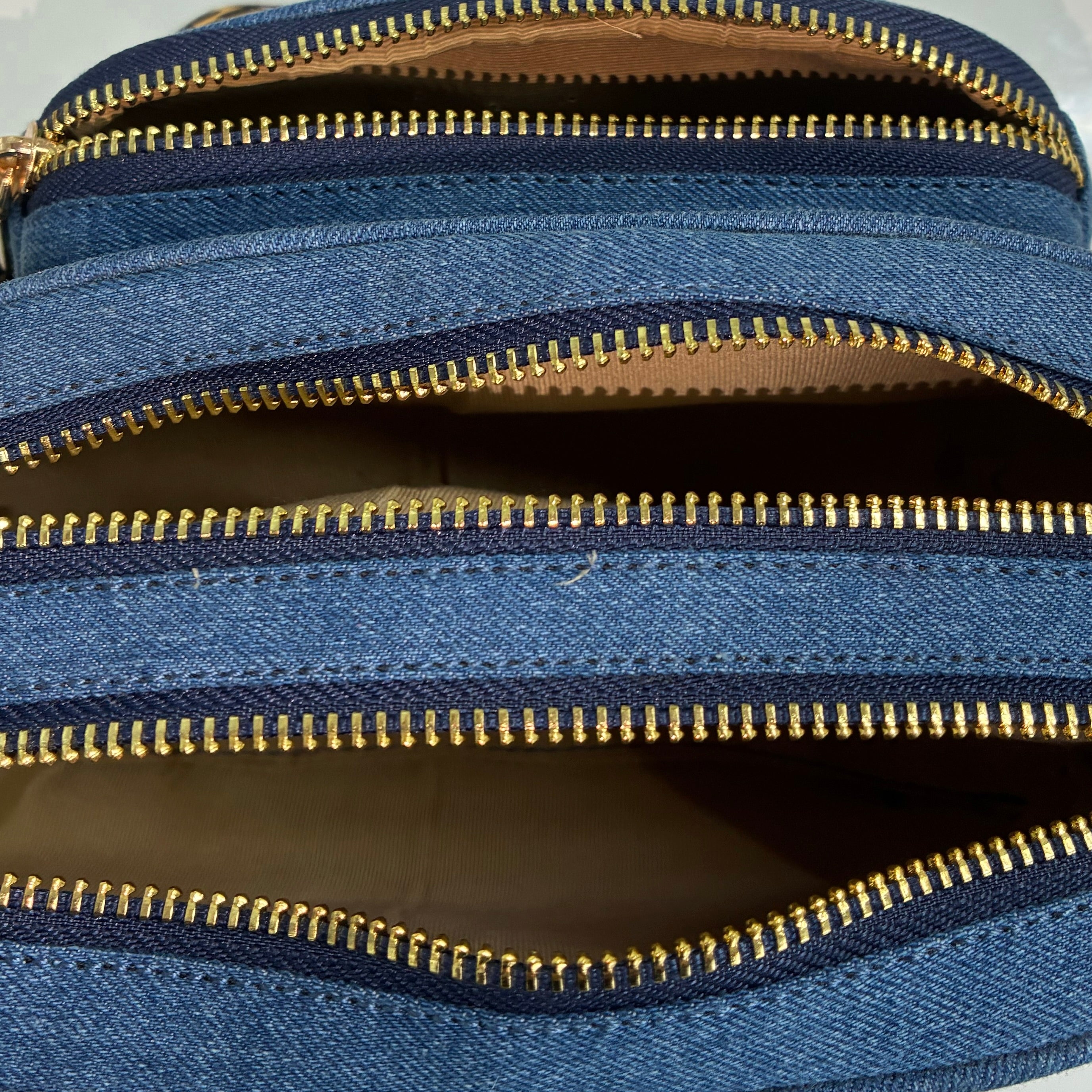 Front zipper pocket detail of Purpleberry Fehu blue denim sling bag