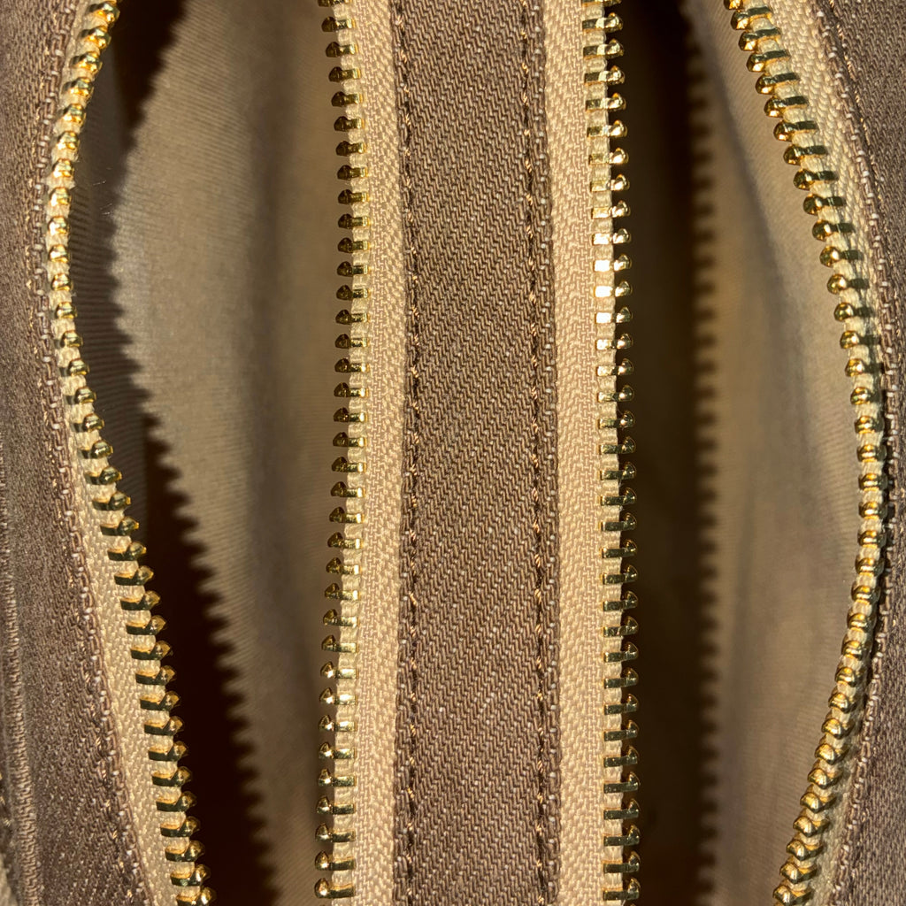 Front zip pocket detail of Purpleberry Fehu brown denim sling bag
