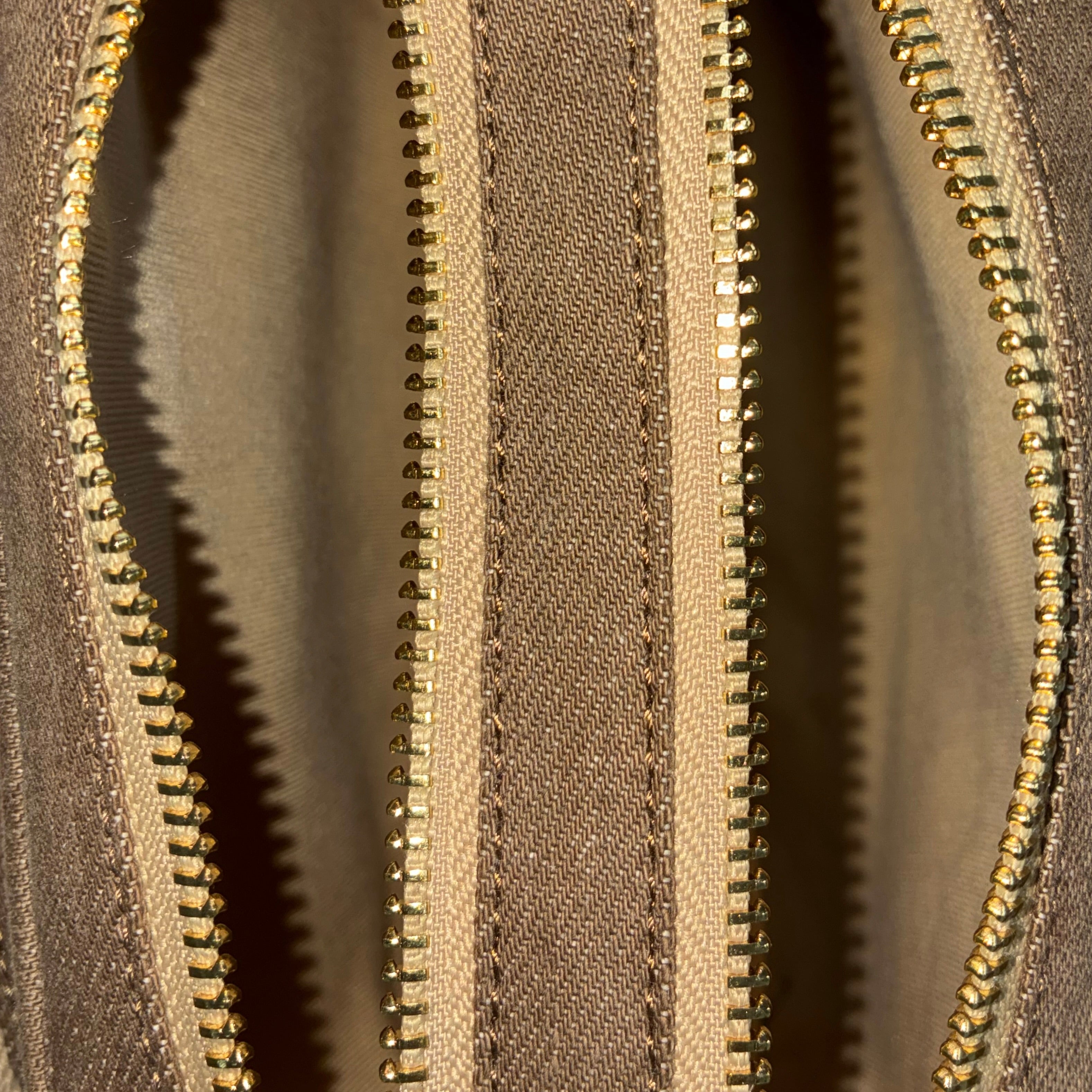 Front zip pocket detail of Purpleberry Fehu brown denim sling bag