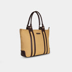 Side angle of beige canvas laptop tote with gold fittings