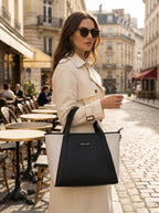 Woman holding black Lexie Office Tote at café