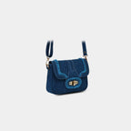 Angled front view of Purpleberry Luna blue denim sling bag with white contrast stitching