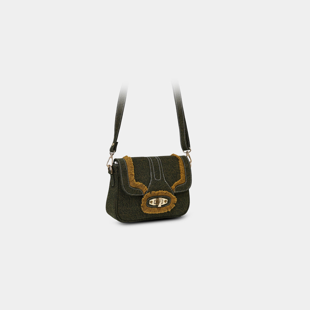Angled front view of Purpleberry Luna green denim sling with contrast stitching