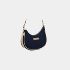 Angled view of Purpleberry Moda blue crescent denim sling with gold hardware