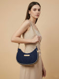 Model wearing Purpleberry Moda blue denim crescent sling bag on shoulder