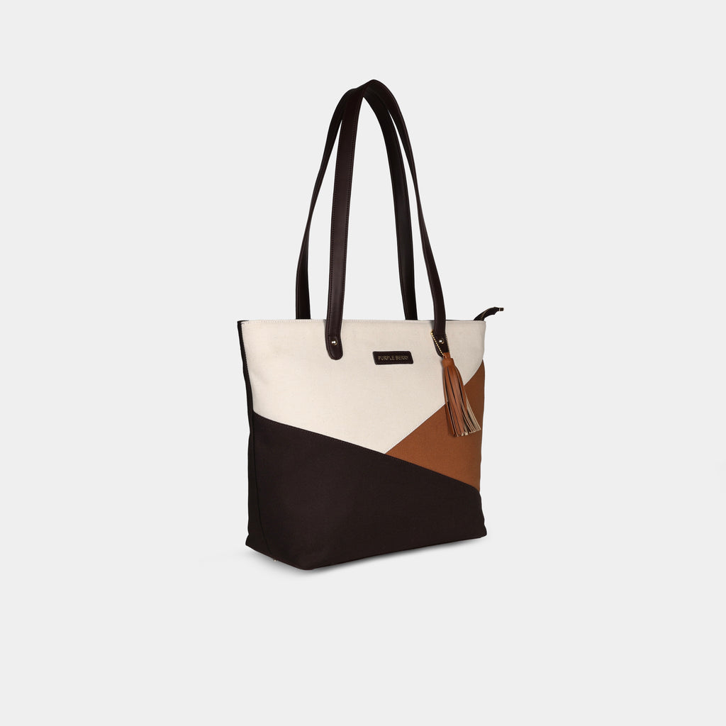 Side angle of multicolor Prism canvas handbag showing depth and panel construction
