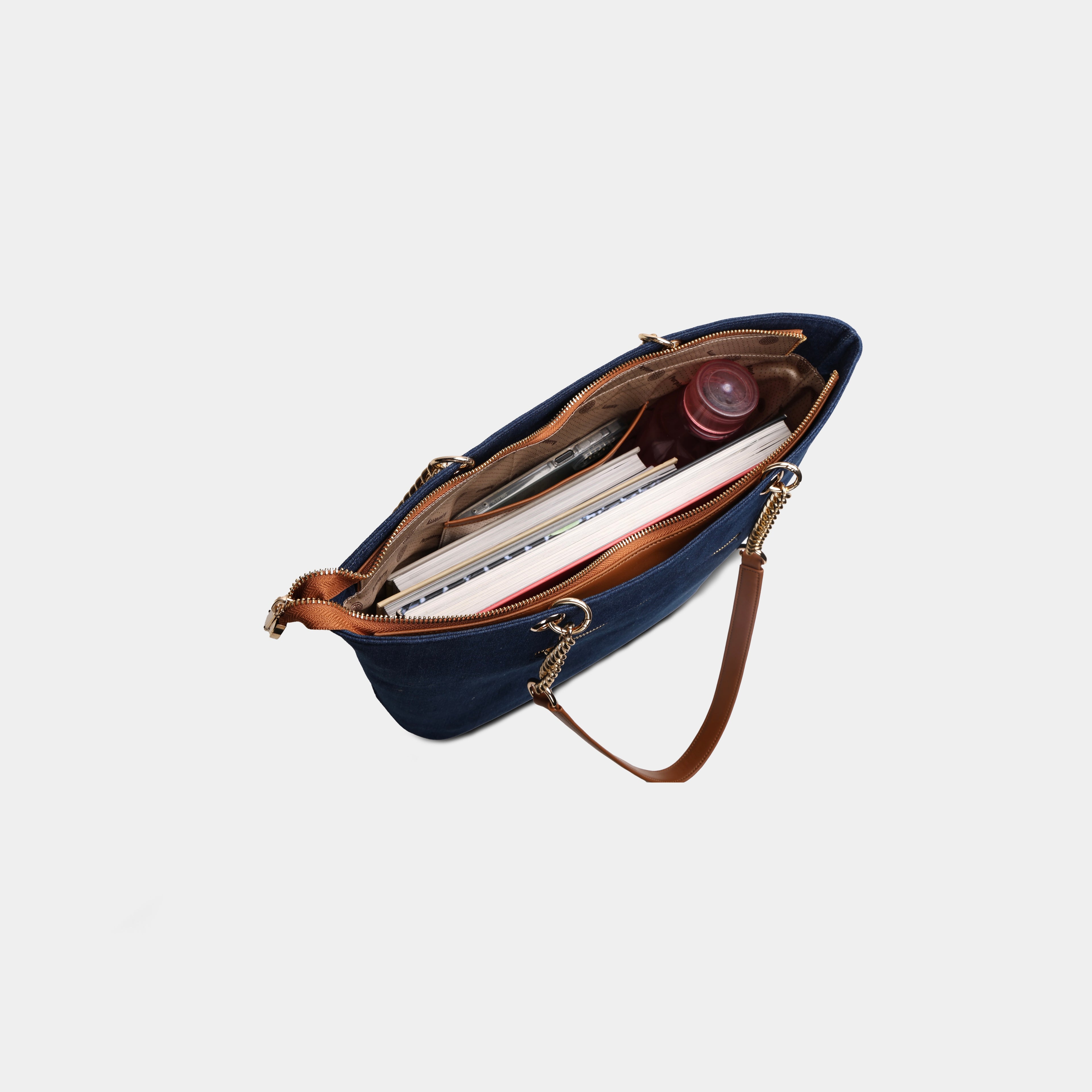 Gold chain and vegan leather strap detail on navy canvas bag