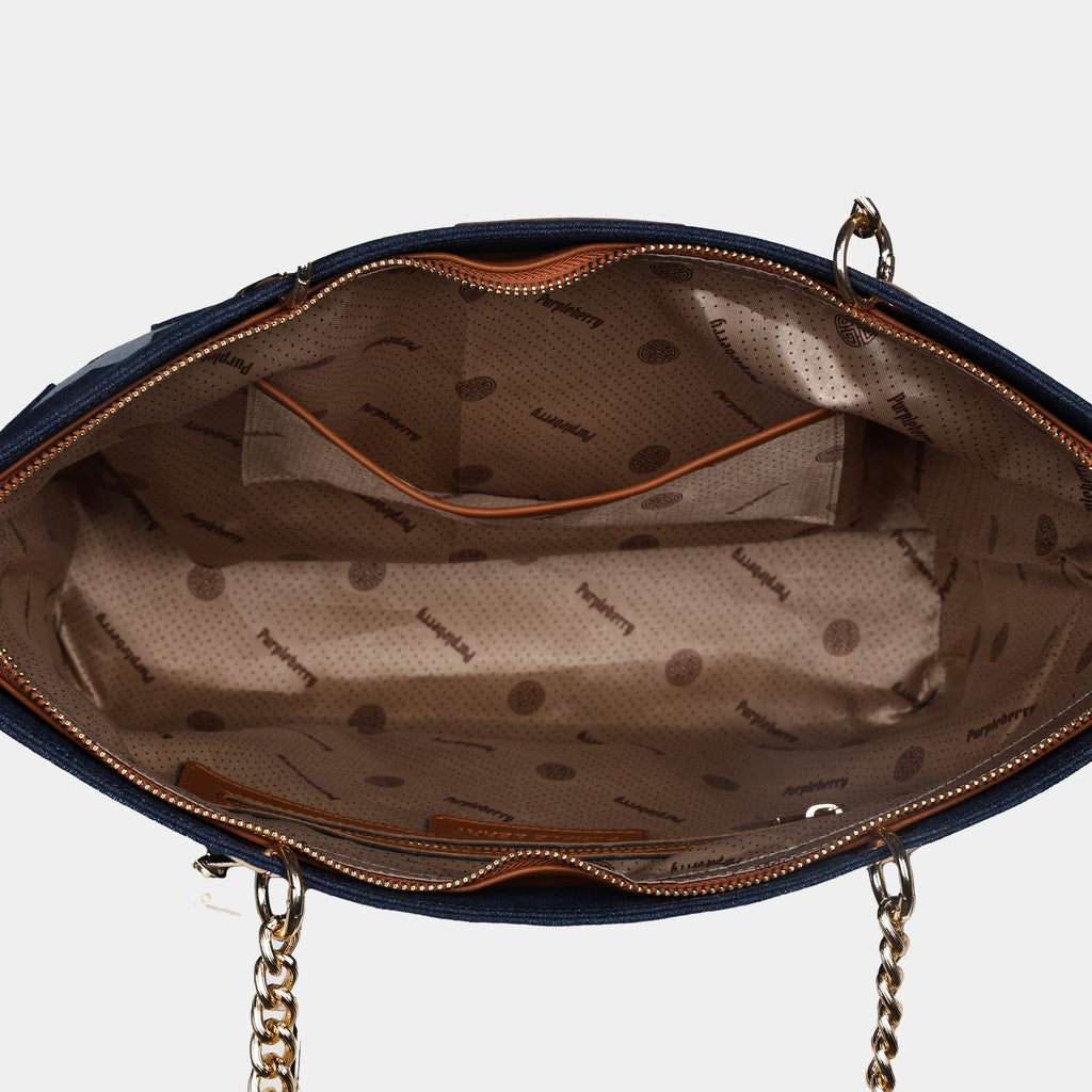 Interior view of a blue Stella handbag with a zip and a slip pocket
