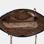 Interior view of a blue Stella handbag with a zip and a slip pocket