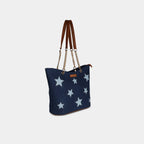 Side view of navy canvas handbag with premium gold chain straps
