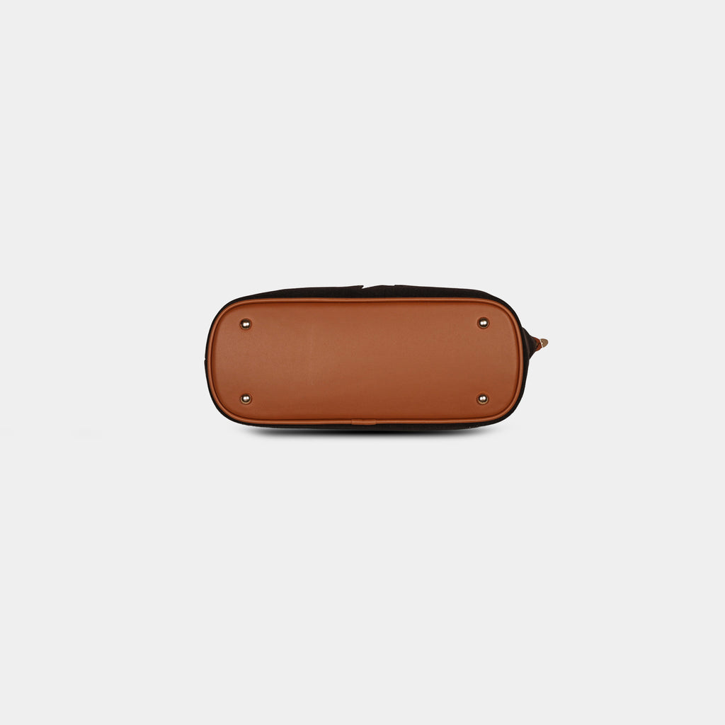 Bottom view of dark brown star print handbag with a vegan leather base strap